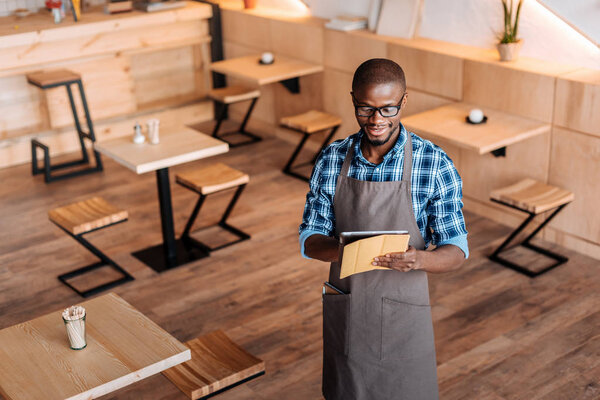 Waiter taking order in cafe