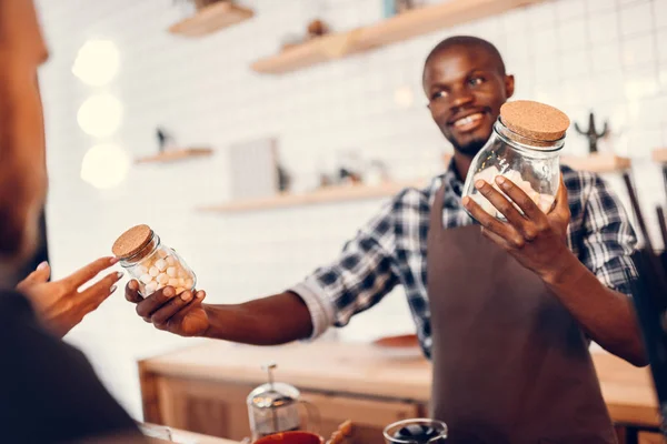 Barista holding jars with marshmallows — Stock Photo, Image