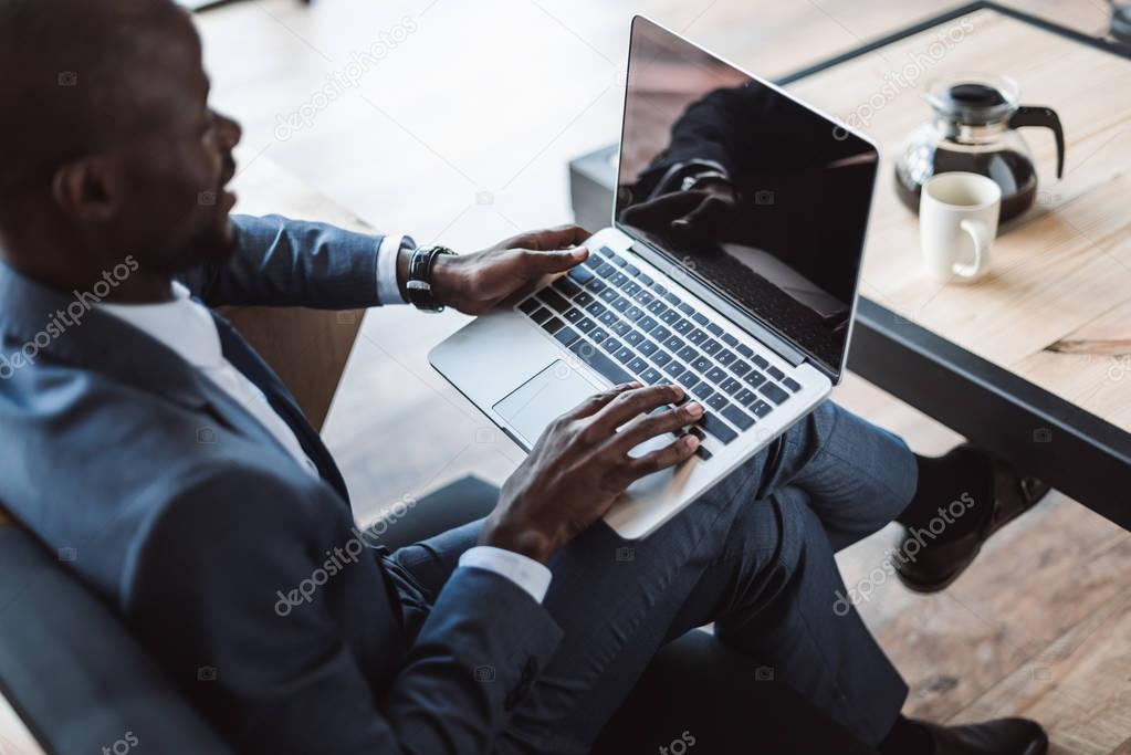 businessman with laptop in cafe 