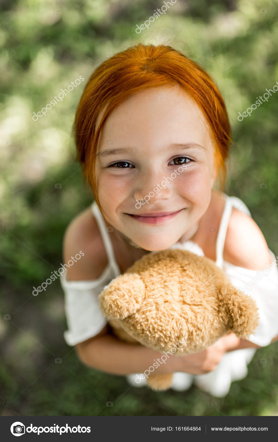 Redhead girl with teddy bear Stock Photo by ©ArturVerkhovetskiy 161664864