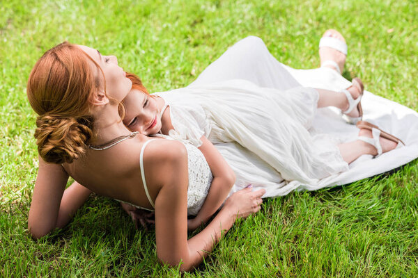 mother and daughter hugging at park