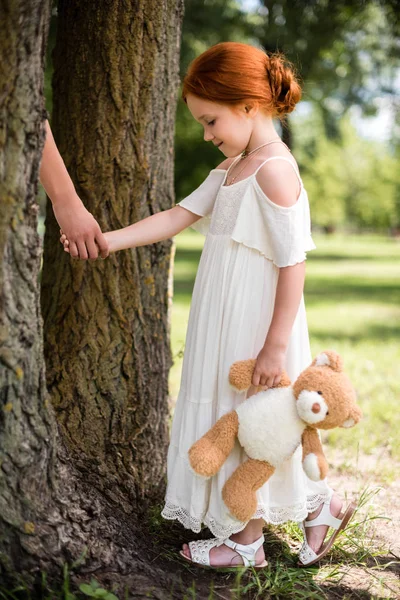 Mother and daughter with teddy bear in park — Stock Photo, Image