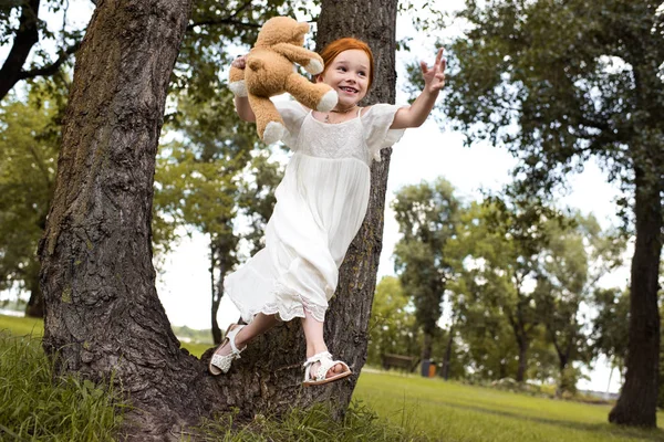 Redhead girl with teddy bear — Stock Photo, Image