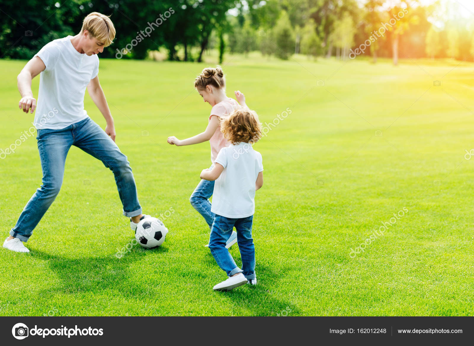 Father With Kids Playing Soccer Stock Photo Image By C Arturverkhovetskiy