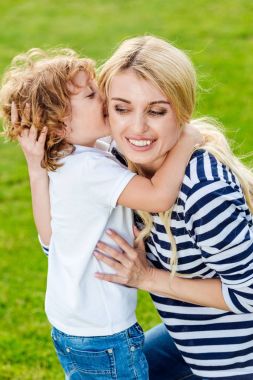 happy mother with son at park clipart