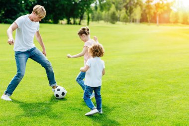 father with kids playing soccer clipart