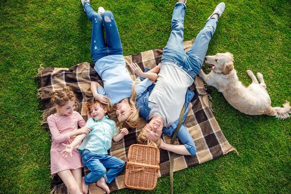 family with dog at picnic