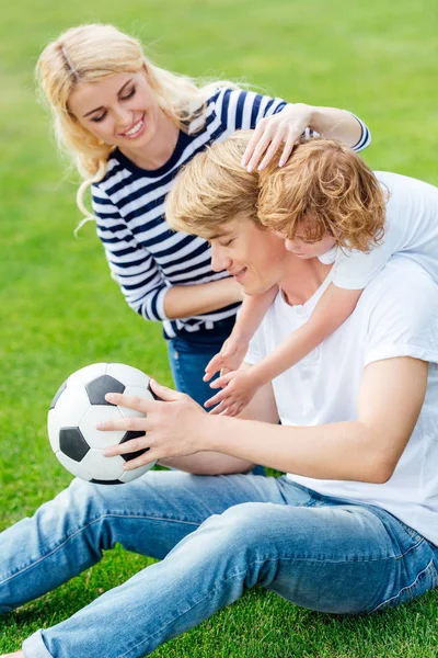 Familie met voetbal spelen in park — Stockfoto