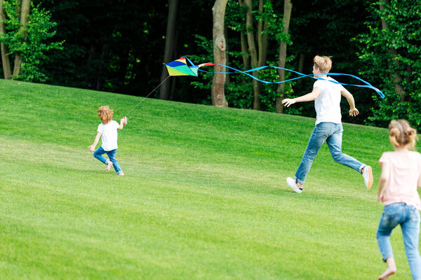 happy family playing with kite