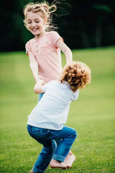 Братья и сестры веселятся в парке — стоковое фото