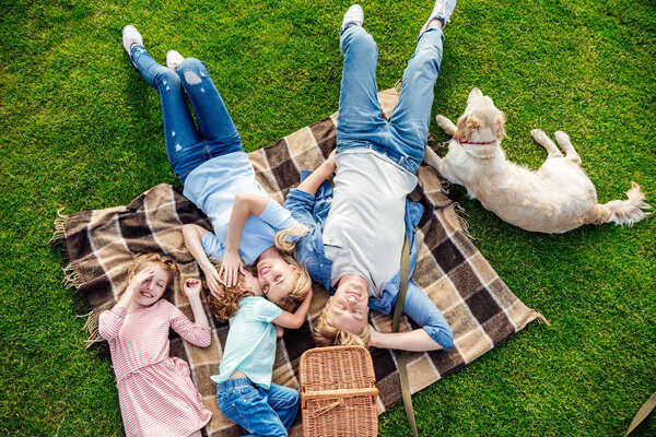 family with dog at picnic