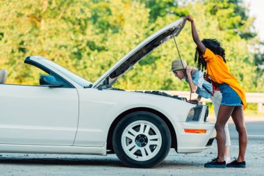 multiethnic women standing near broken car clipart