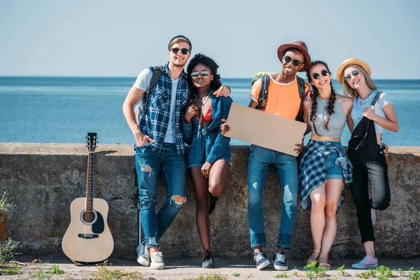 Multicultural people with empty cardboard hitchhiking — Stock Photo, Image