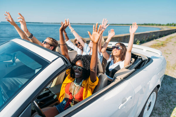 multiethnic friends riding car