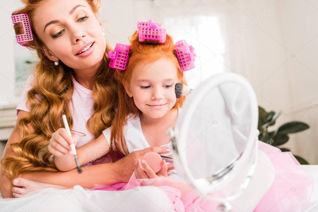 mother and daughter doing makeup