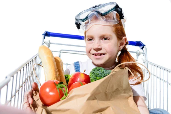 Redhead child with shopping trolley — Stock Photo, Image