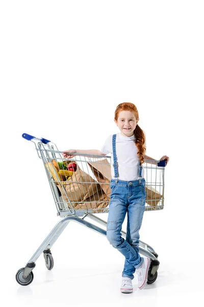 Redhead child with shopping trolley — Stock Photo, Image