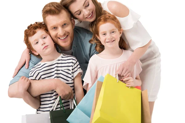 Gelukkige familie met shopping tassen — Stockfoto