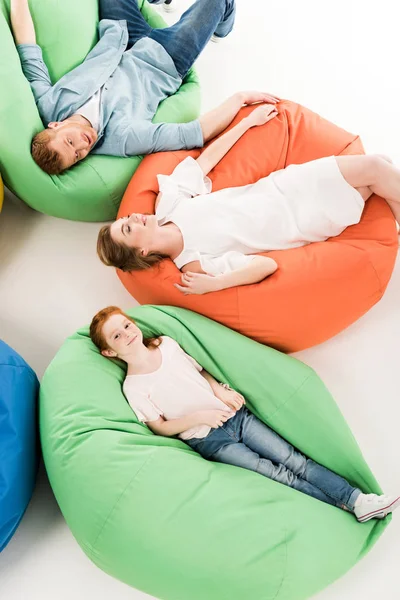 Parents with daughter on bean bag chairs — Stock Photo, Image