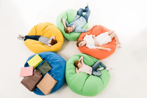 Family on bean bag chairs after shopping — Stock Photo, Image