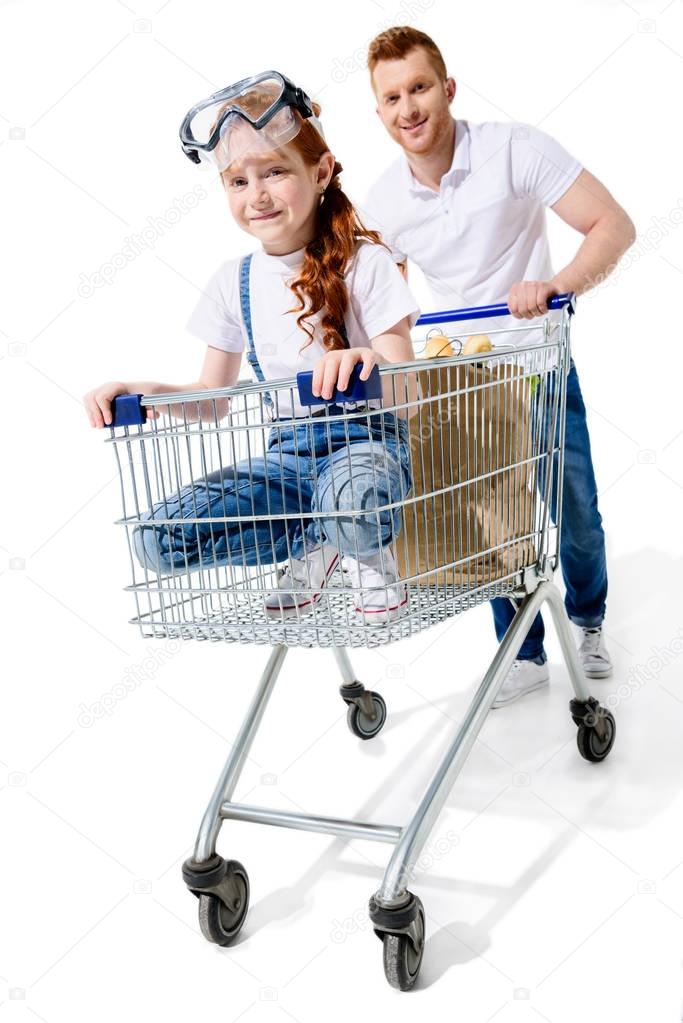 father and daughter with shopping trolley