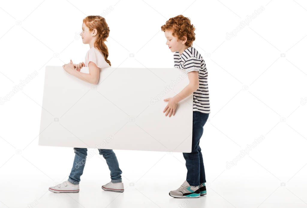 redhead siblings with shopping trolley