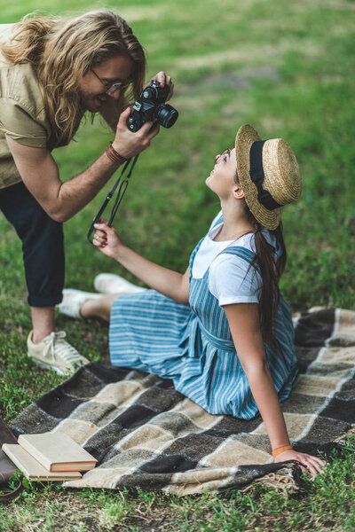 man taking photo of woman
