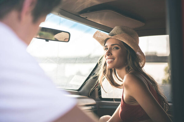 woman smiling to man in car window