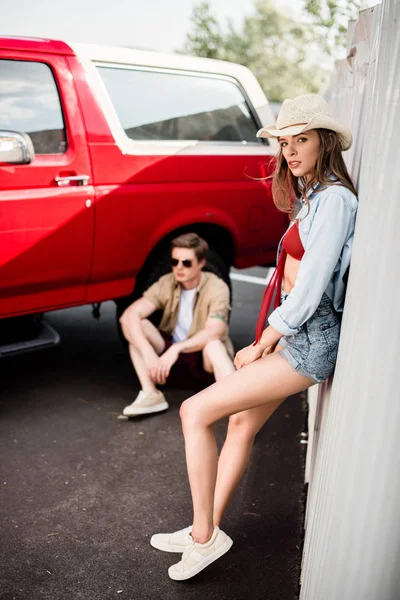 Casal posando ao lado de carro vintage — Fotografia de Stock