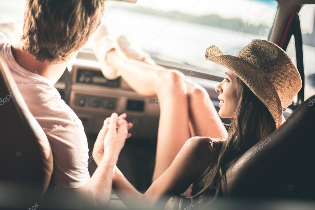 couple holding hands in car