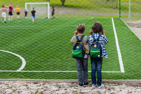 schoolboys on soccer field 