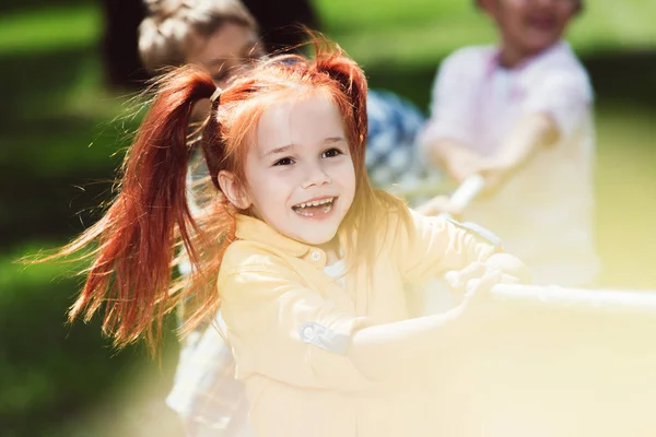 Children playing tug of war — Stock Photo, Image