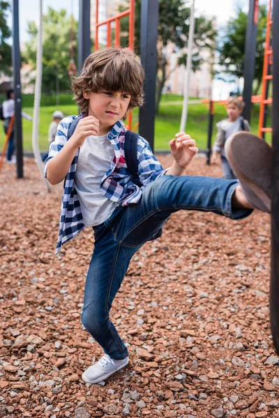 Child hitting punching bag — Stock Photo, Image