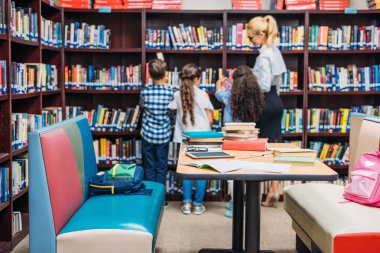 teacher with kids in library clipart