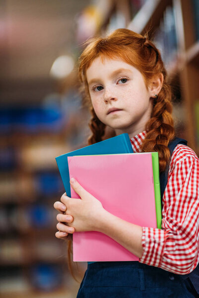 redhead schoolgirl in library