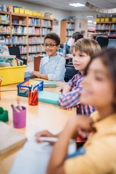 kids having lesson in library
