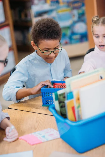 Kids choosing supplies in box — Stock Photo, Image