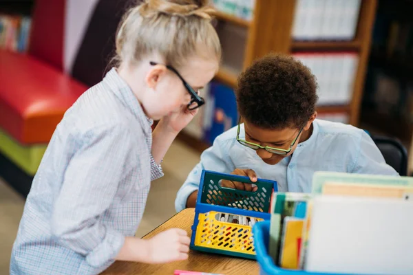 Kids choosing supplies in box — Stock Photo, Image