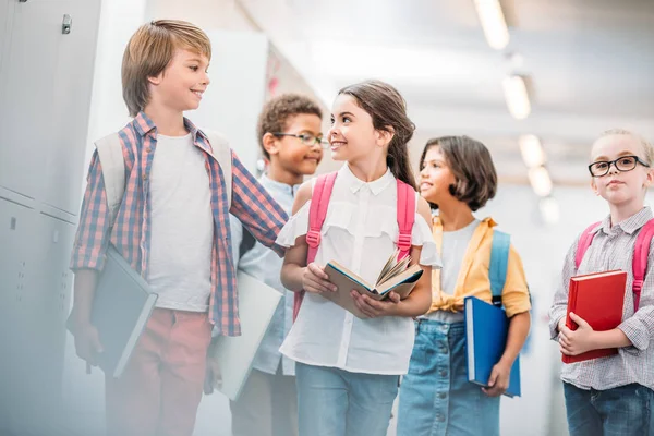 Schoolchildren in school corridor — Stock Photo, Image