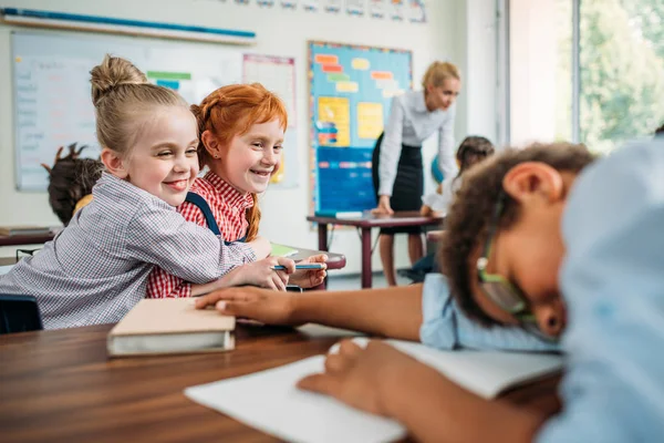 Schoolgirls laughing of sleeping classmate — Stock Photo, Image