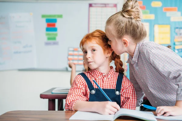 Little girls gossiping in class — Stock Photo, Image