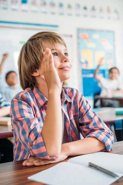 Schoolboy raising hand — Stock Photo, Image