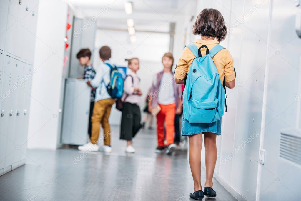 girl with backpack in school