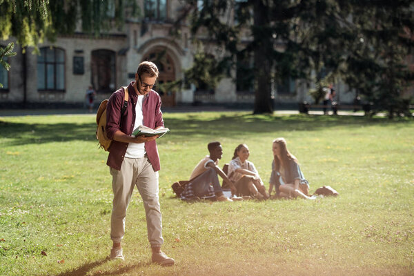 student reading and walking