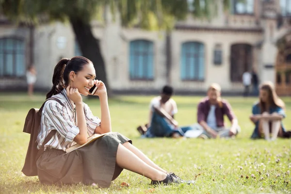 Asian student talking on smartphone Royalty Free Stock Photos