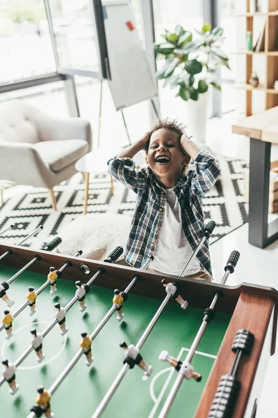 Boy playing table football — Stock Photo, Image