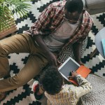 Father and son with digital tablet