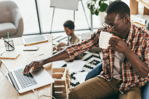 african american father and son in office