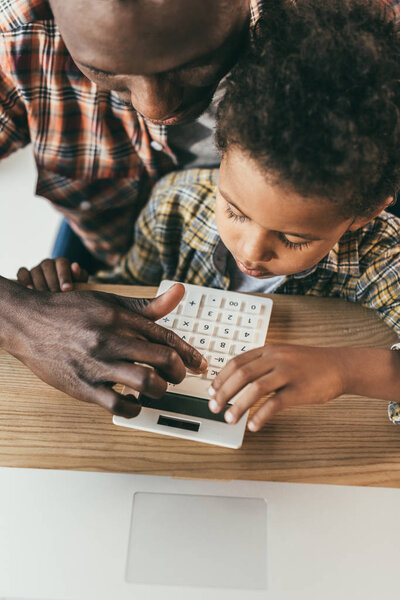 father and son with calculator