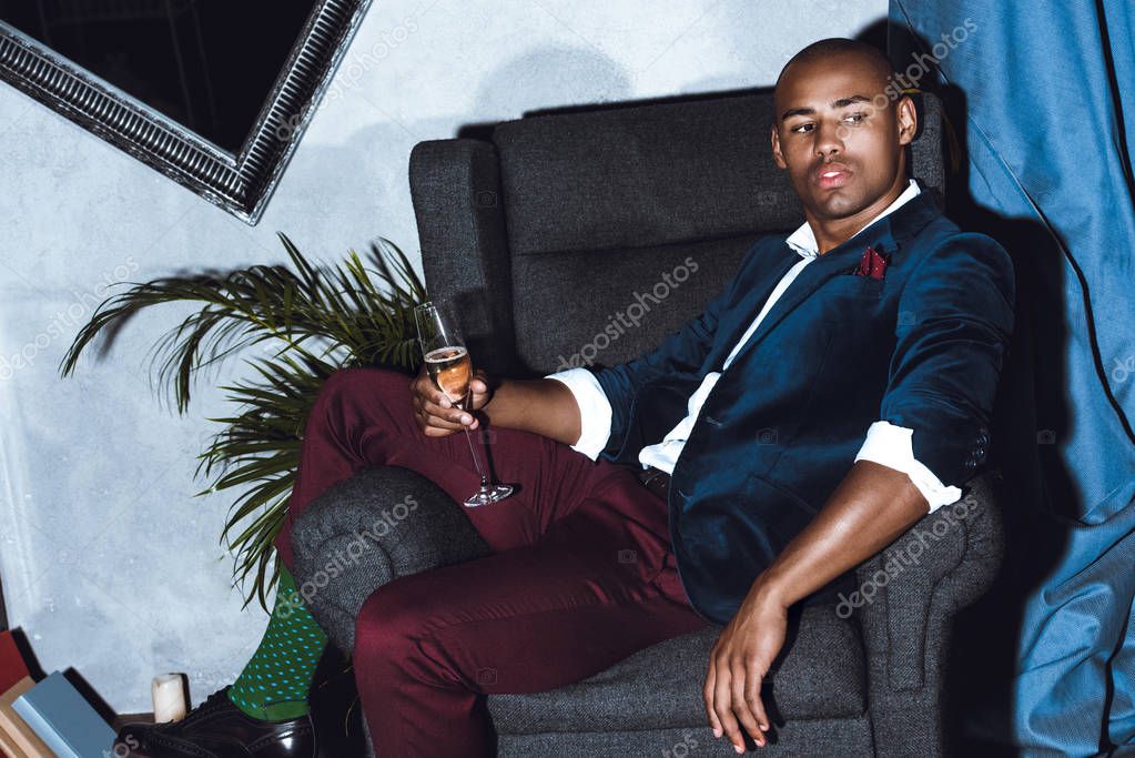 Man sitting in armchair on party — Stock Photo © ArturVerkhovetskiy